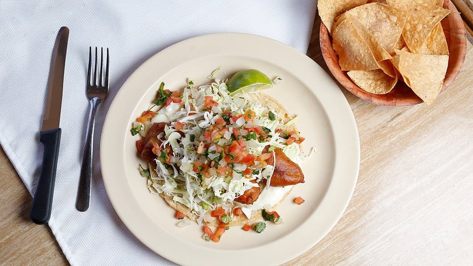 Close-up of plated Mexican food with bright garnishes.