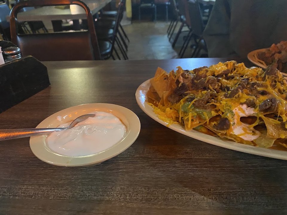 Close-up of a menu listing quesadillas and nachos.