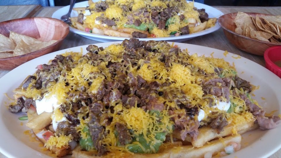 Close-up of a menu listing quesadillas and nachos.