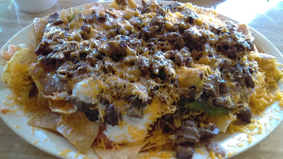 Close-up of a menu listing quesadillas and nachos.