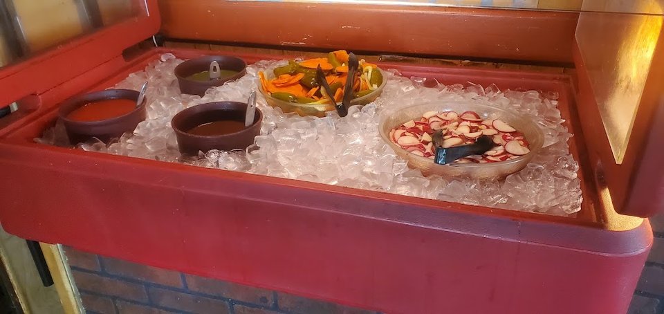 Printed menu with burritos, tacos, and plates.